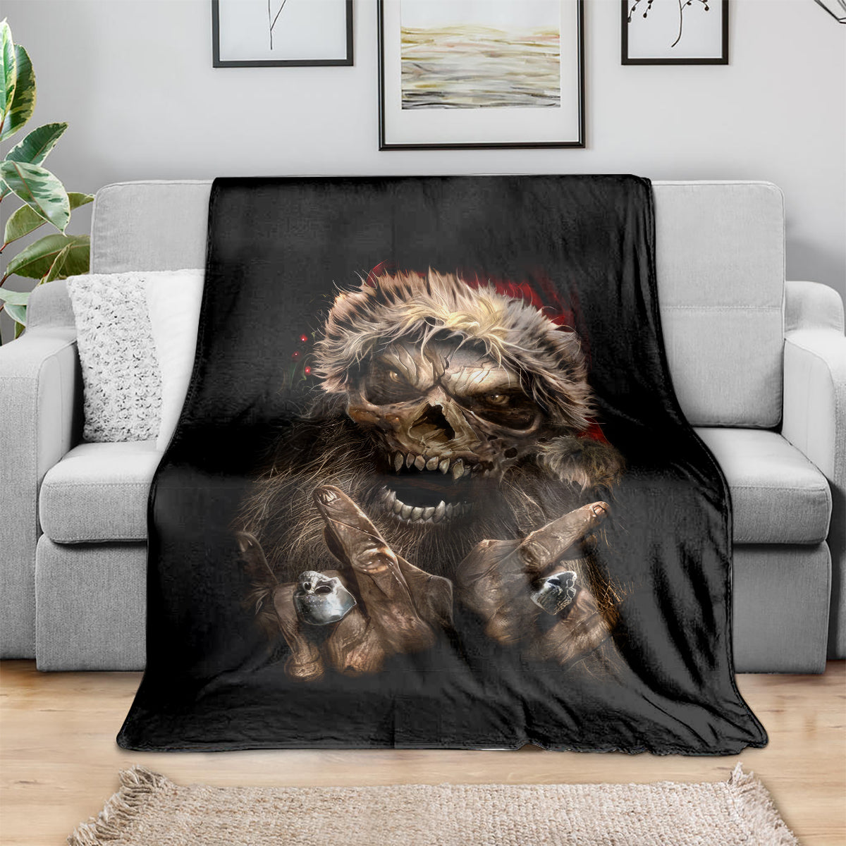 Black skeleton Santa blanket draped on sofa, snarling skull with raised hands