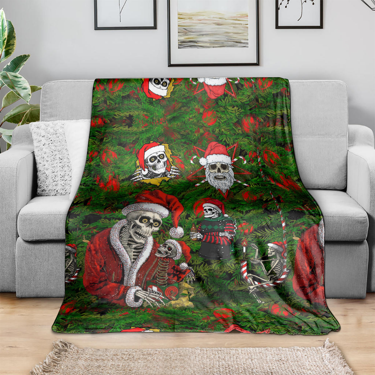 Green throw blanket featuring multi skeleton Santa characters in red-and-green holiday scene.