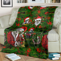 Green skeleton Santa Christmas blanket with candy-cane and wreath pattern details.