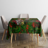 Green patterned Christmas tablecloth with skeleton Santas on red and green foliage