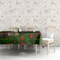Green Christmas tablecloth with skeleton Santa motif across the table surface