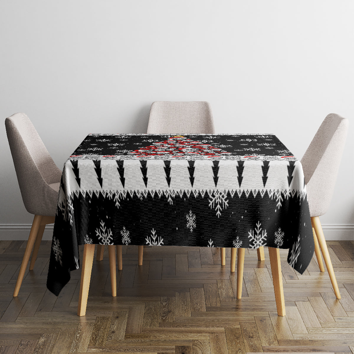Black Christmas tablecloth covering square table with jagged snowflake and arrow borders