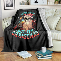 Black Christmas blanket with skeleton Santa graphic and quote text, draped over couch