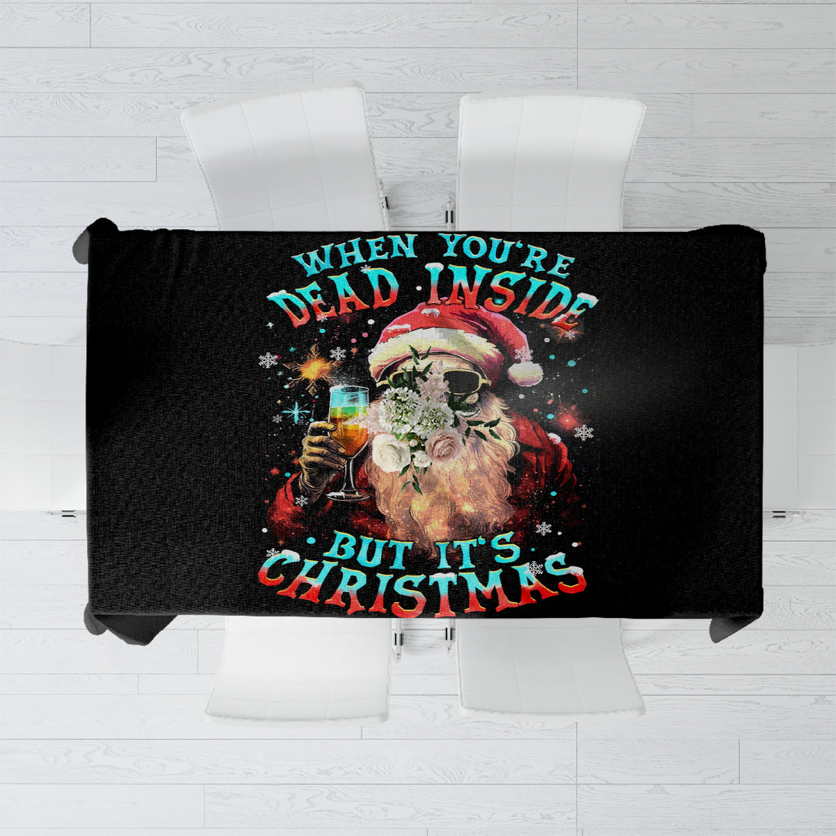 Black tablecloth with colorful skeleton Santa graphic and “It’s Christmas” text