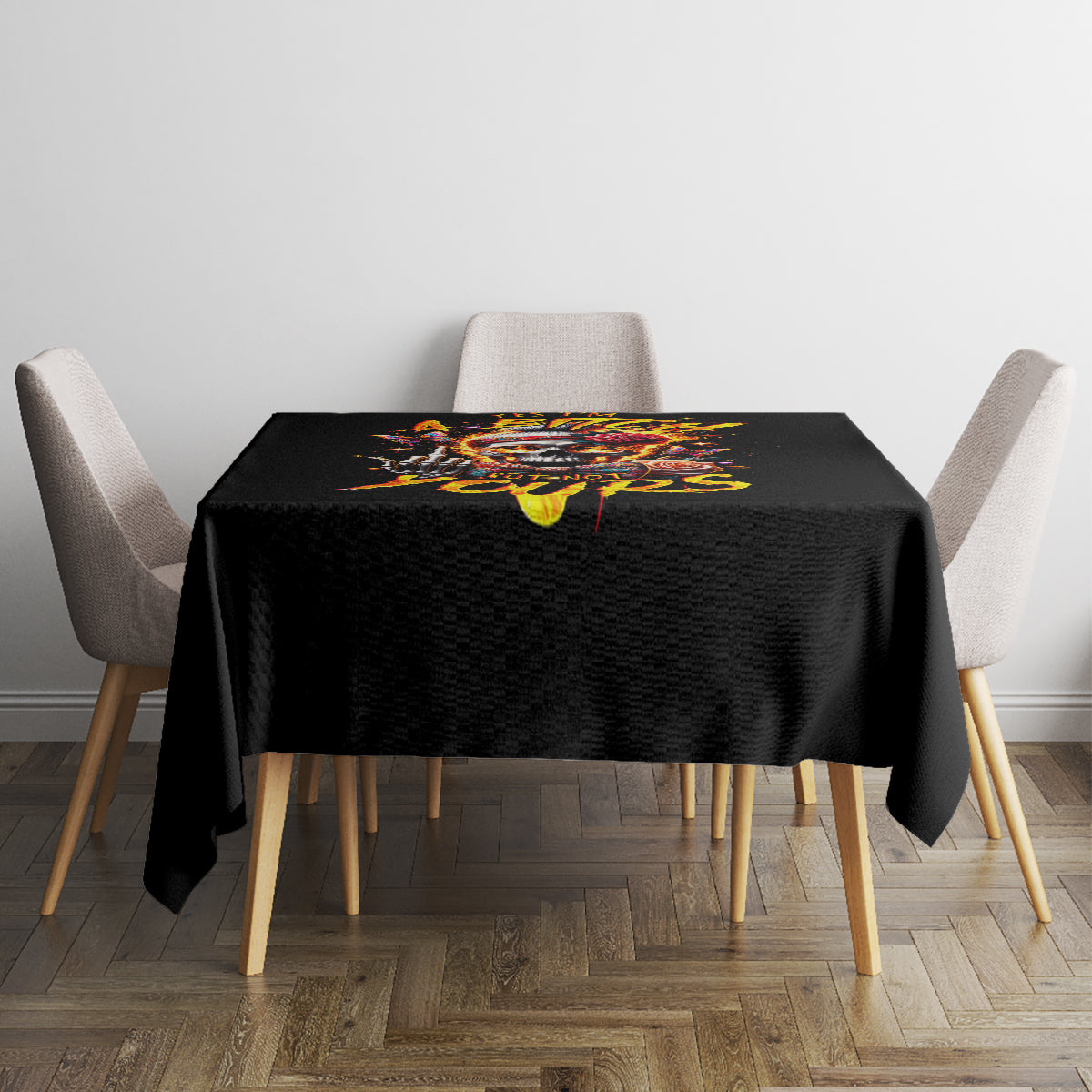 Black tablecloth featuring colorful skull lettering on a small square dining table