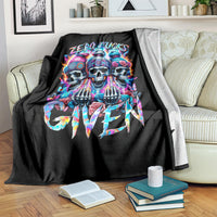 Black throw blanket with colorful skull artwork and graffiti lettering on sofa