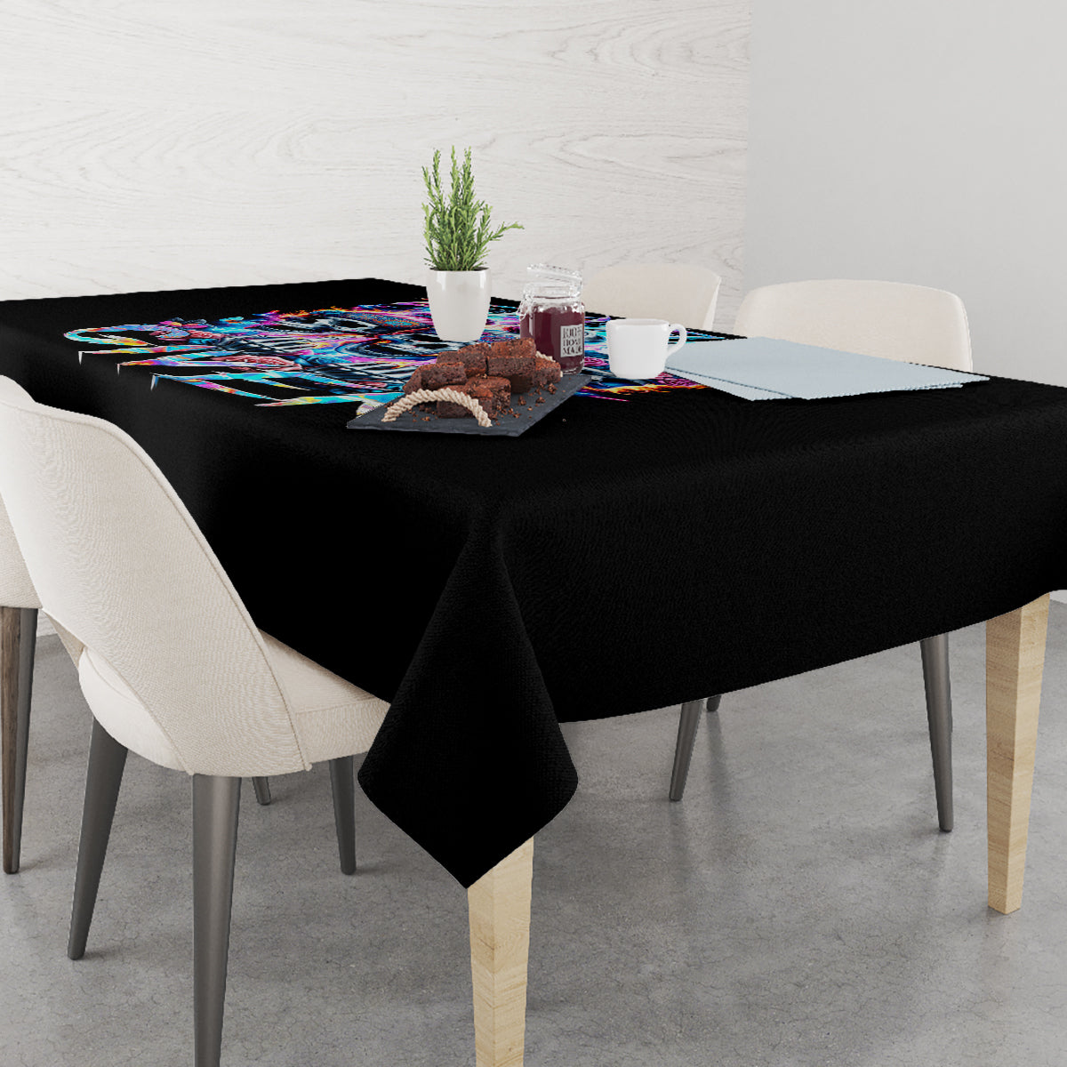 Black tablecloth on dining table with centered colorful skull and text graphic