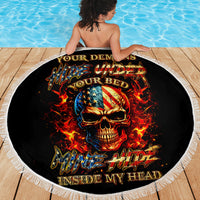 Black round beach blanket with white fringe, fiery skull face and flame accents