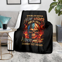 Black fire skull blanket on gray sofa with flaming skull artwork and gold lettering