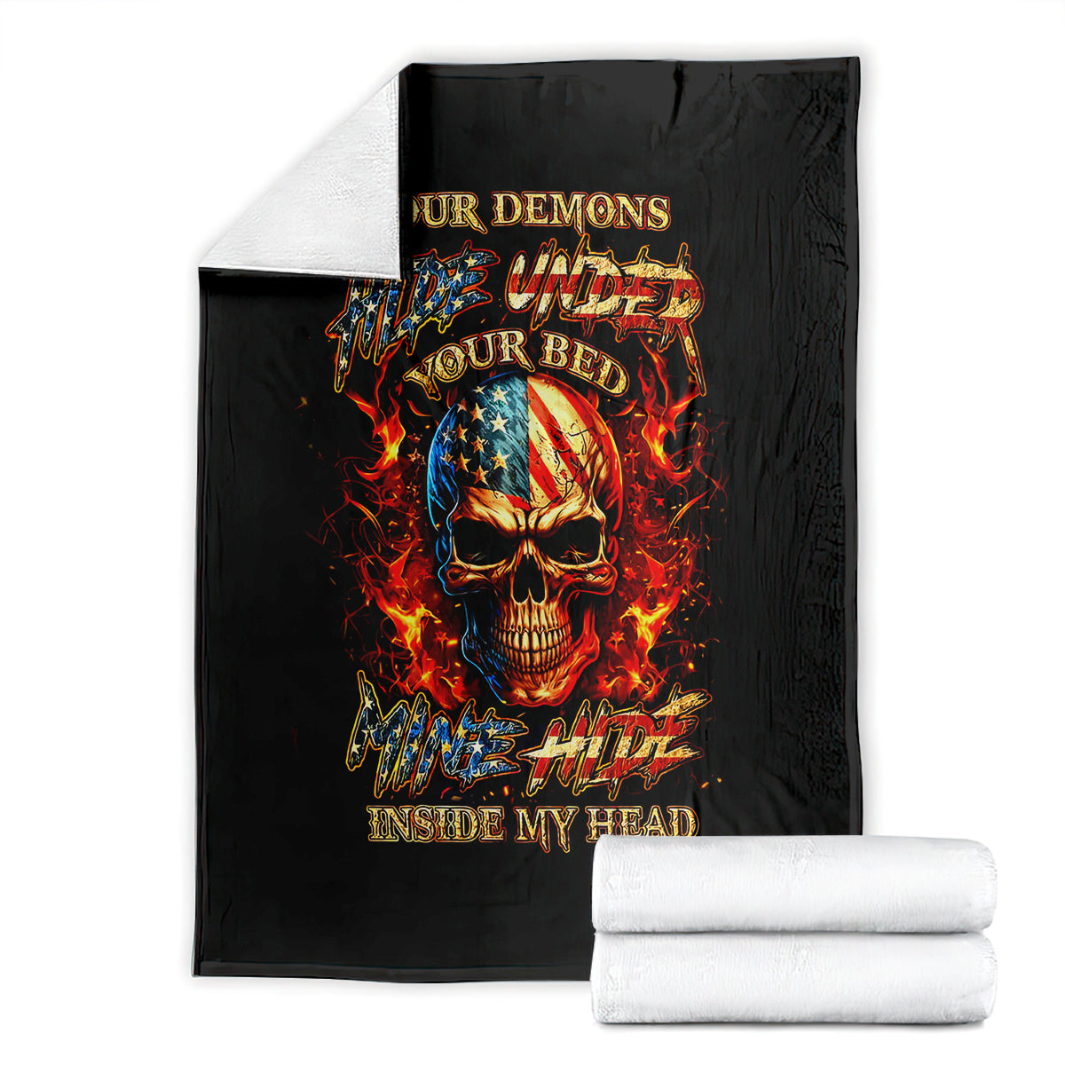 Black fire skull blanket with flaming skull graphic, shown with folded white towels