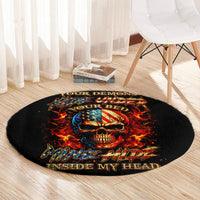 Black round carpet rug with fiery skull design in red flames and blue accents at center
