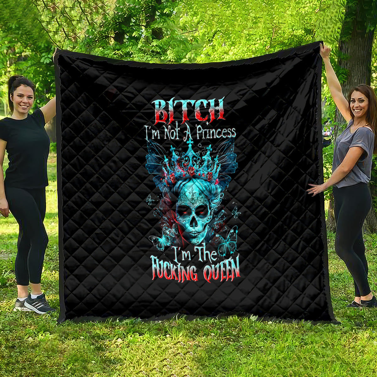 Black quilt blanket outdoors with blue skull graphic and “I'm not a Princess” text