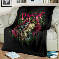 Black skull and roses blanket spread on a couch, colorful band logo graphic