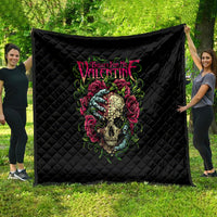 Black quilted blanket spread outdoors with colorful skull and rose design