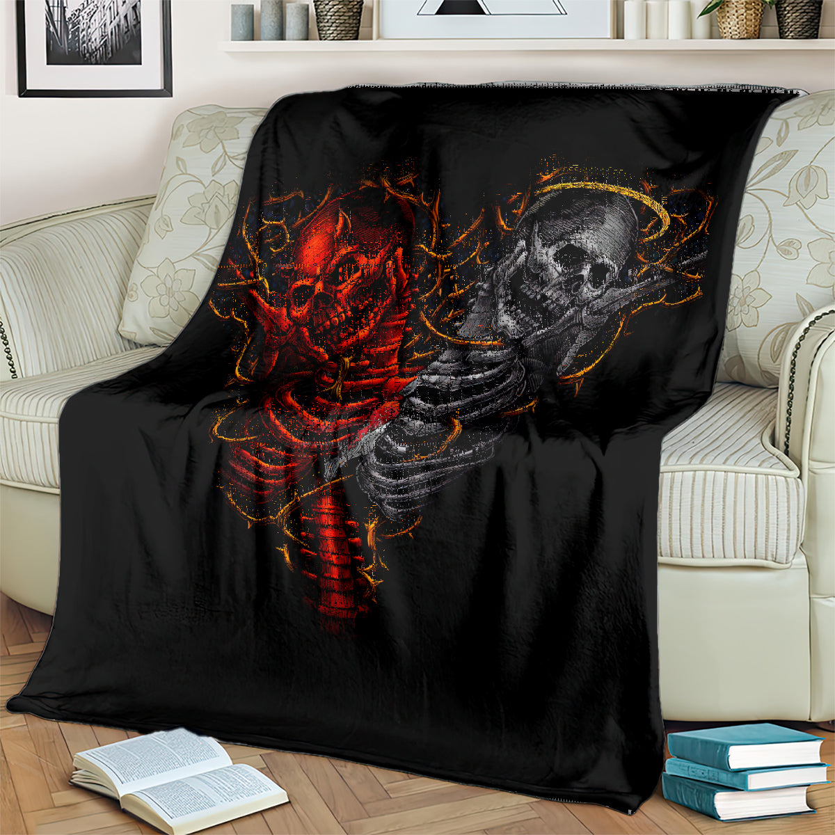 Black throw blanket with red and gray skull skeleton graphic, laid on a sofa