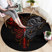 Black round skull rug with red-and-orange devil ribcage and gray angel ribcage