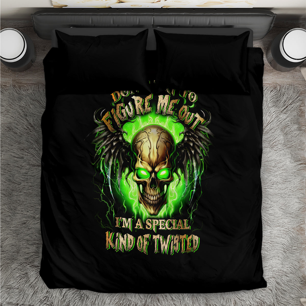 Black bedding set top-down view with green skull graphic and two matching pillowcases