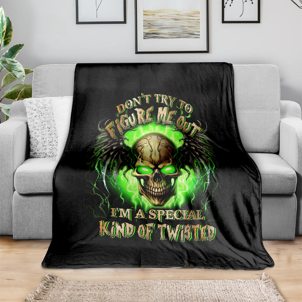 Black skull graphic throw blanket with neon green text and glowing skull design