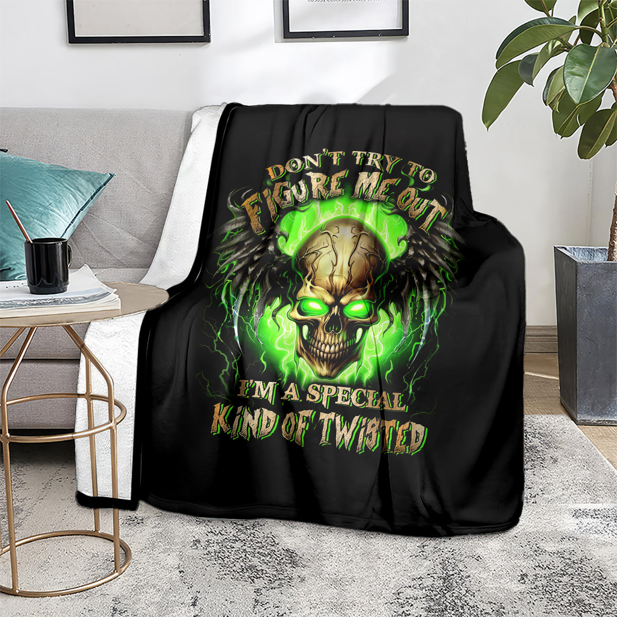 Black skull graphic blanket on sofa with neon green glowing skull and bold lettering