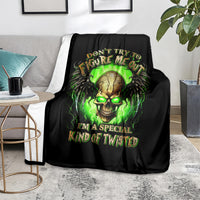 Black skull graphic blanket on sofa with neon green glowing skull and bold lettering