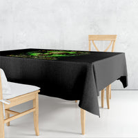 Black skull graphic tablecloth draped over rectangular table with green neon design.