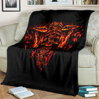 Black skull flame blanket draped over a couch, bold flaming skull face