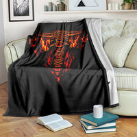 Black blanket with flaming skull graphic, draped over the couch back