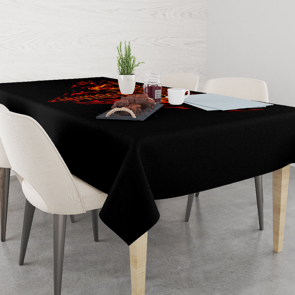 Black tablecloth with red-orange flame skull motif across the dining table