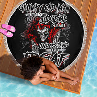 Black round beach blanket with skull graffiti graphic and white fringe trim