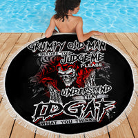 Black round beach blanket with skull graffiti artwork and white fringe edge