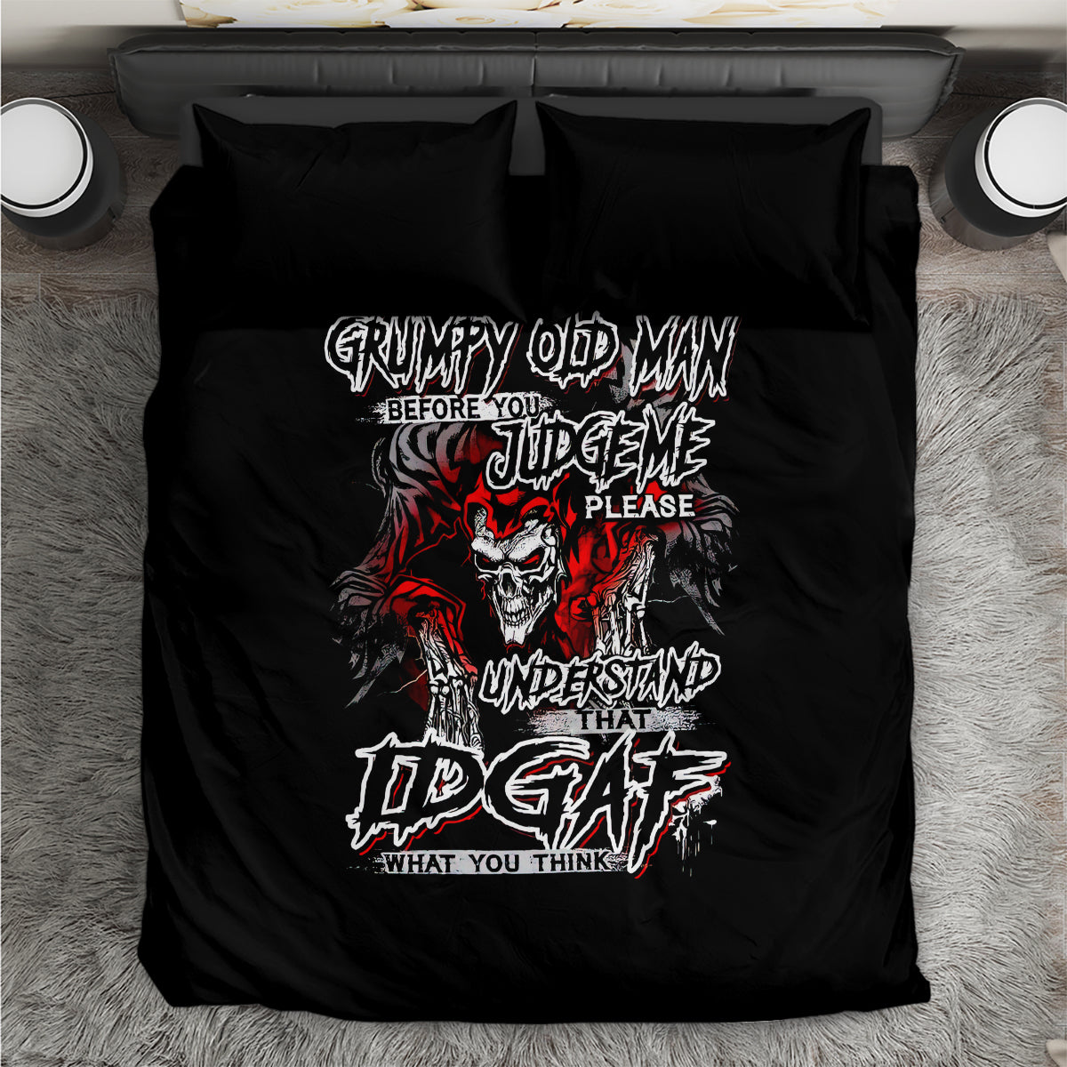 Black duvet cover and pillowcases laid flat with grumpy skull typography graphic