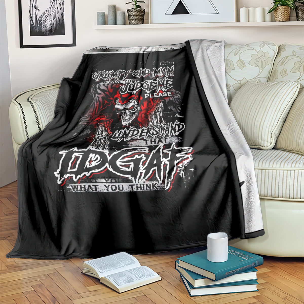 Black skull graphic blanket with red and white text, draped over striped sofa