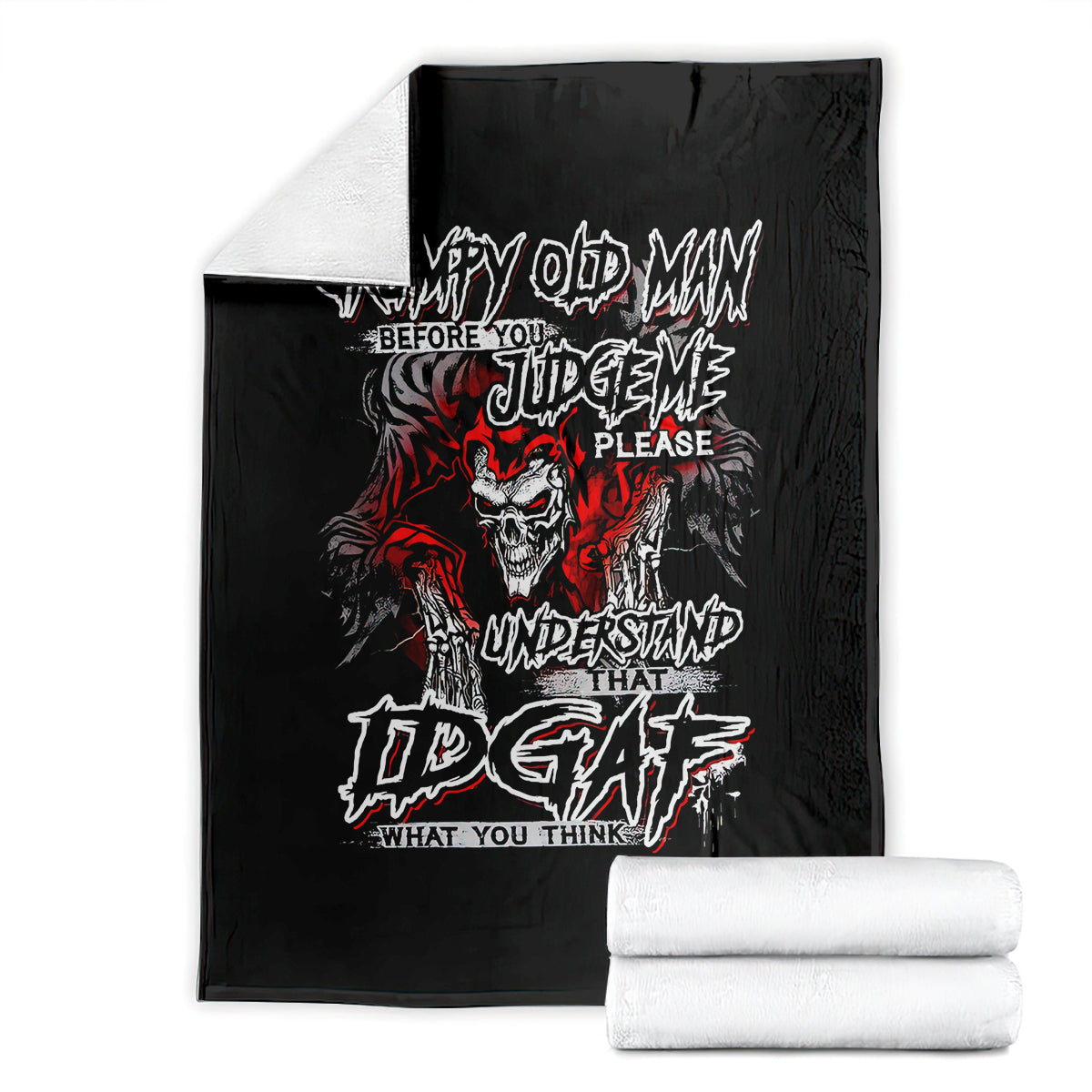 Black skull graphic blanket with red and white text, with rolled stacks
