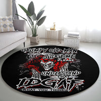 Black round rug with skull graphic and red/white lettering on the floor