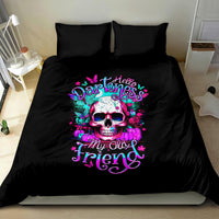 Black bedding set with large skull graphic and pink cursive text on duvet