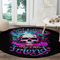 Black round area rug with bright skull graphic and ornate purple lettering