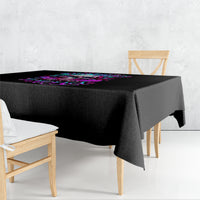 Black tablecloth draped over a table with neon skull graphic