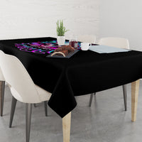 Black tablecloth with neon skull graphic and tabletop items