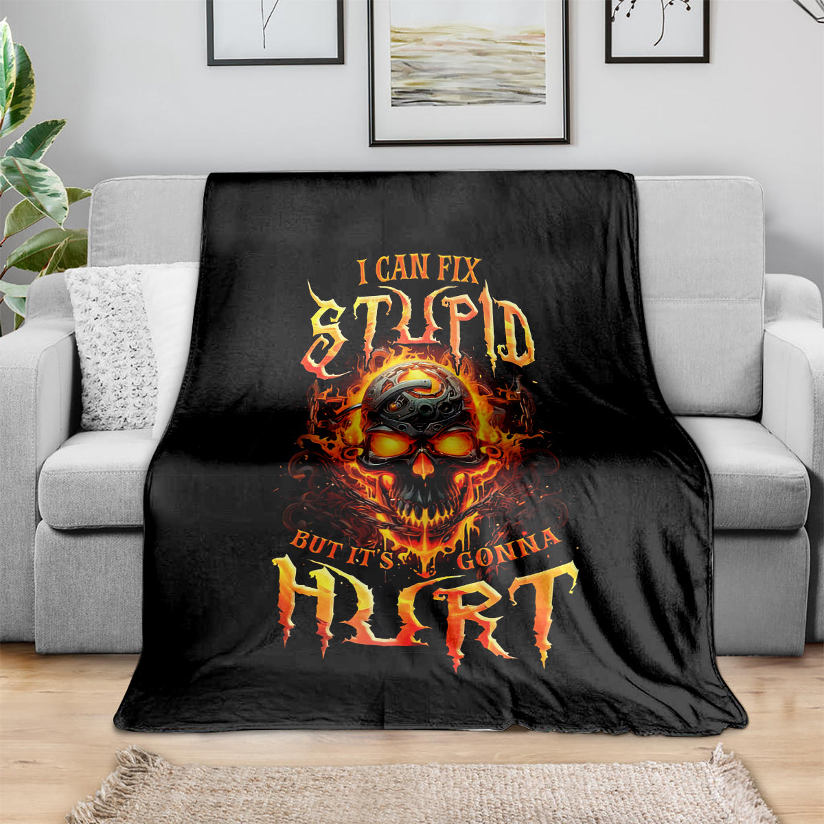 Black blanket with flame skull graphic, orange and yellow lettering on fabric.