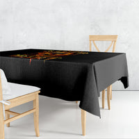 Black tablecloth draped over rectangular table with flame skull design on top