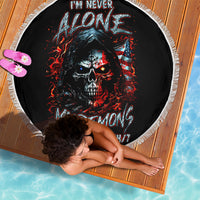 Black round beach blanket with skull and flame graphic, white fringe edge