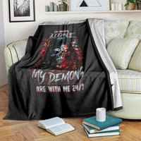 Black skull demon graphic blanket on couch with books and cup