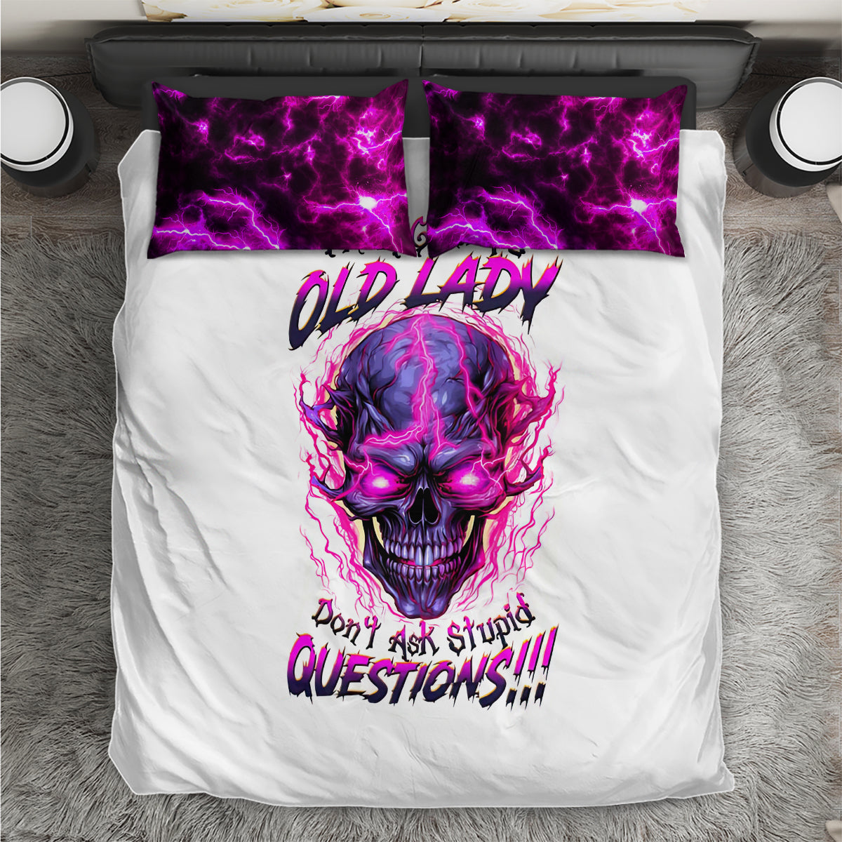 White comforter with purple skull face and text, plus two purple-patterned pillowcases