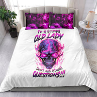 White bedding set with purple skull print and two matching purple pillowcases