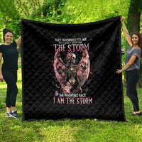 Black quilt with diamond quilting and a central skull angel graphic in pink and gray