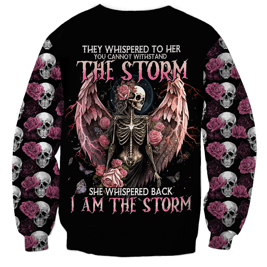 Black unisex sweatshirt with central angel-skeleton skull, roses, and storm text; skulls on sleeves