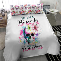 White bedding set featuring large watercolor skull graphic with floral accents on duvet