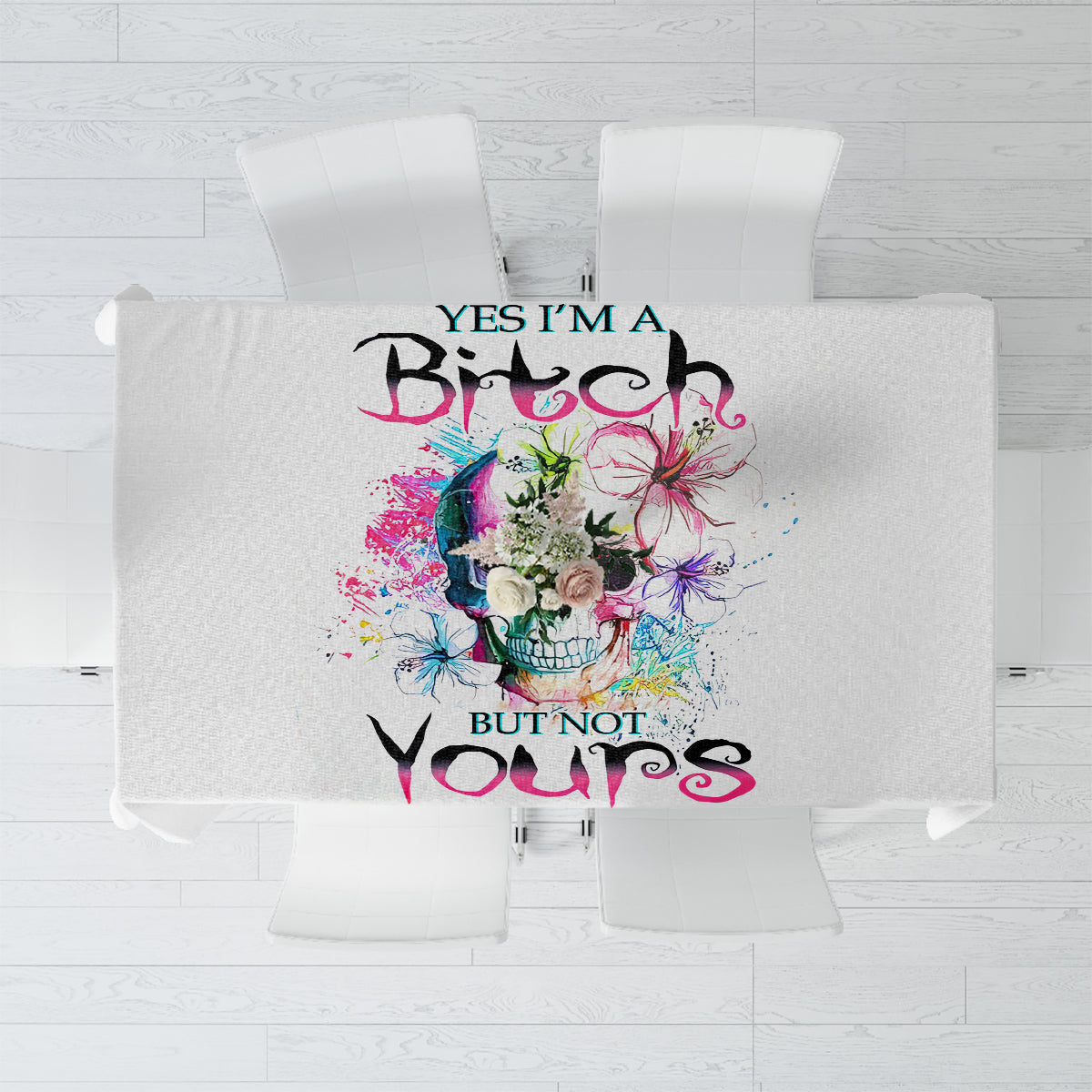 White tablecloth featuring a watercolor skull graphic with colorful splatters and text