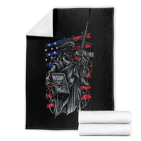 Black skull freedom graphic blanket with stacked white towels beside it