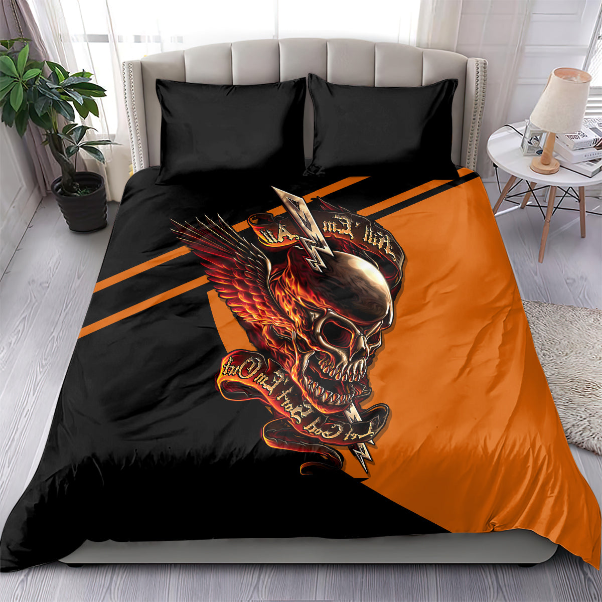 Orange-and-black skull wing duvet with two black pillowcases in a bed setup
